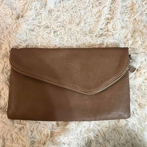 Woman’s tan Urban Expressions clutch purse
